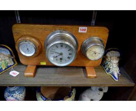 A Sestrel chrome bulkhead timepiece, 14cm diameter, mounted on a teak plaque with barometer and thermometer. 