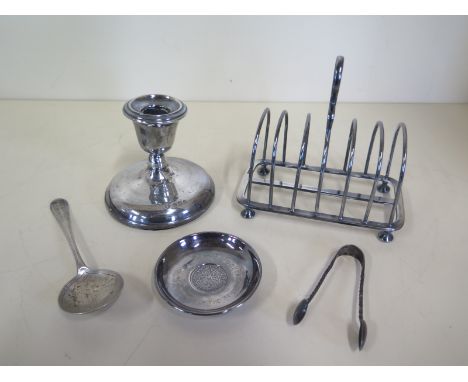 Five pieces of silver, a toast rack, spoon, coin dish, nips and a weighted candlestick - total weighable silver approx 6.9 tr