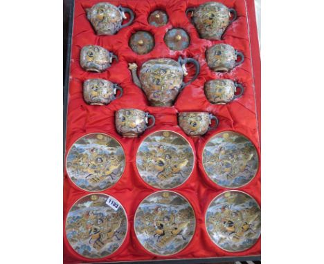 A Satsuma Japanese six setting tea service, with dragon handles, in original presentation case, some crazing to interior but 