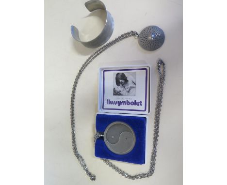 Three pieces of Jorgen Jensen pewter jewellery to include a Yin Yang pendant on chain, a bangle no 988 and another pendant an