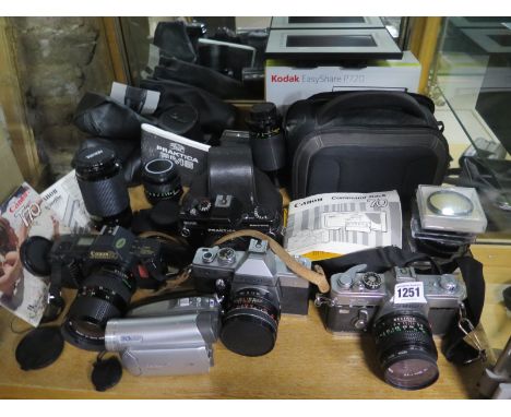 A collection of photographic equipment to include a Canon T70, a Canon FTb, Two Prabitca cameras, a Panasonic NV-G527, assort