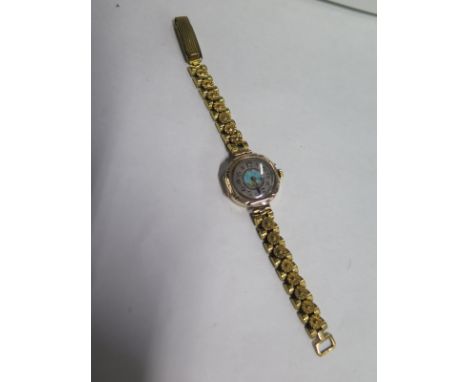 A 9ct gold manual wind wristwatch on a plated strap, running but with damage to dial 