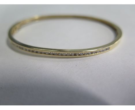A 14ct diamond set bangle, approx 7.5gs 5cm x 6.5cm - minor usage marks, overall good condition