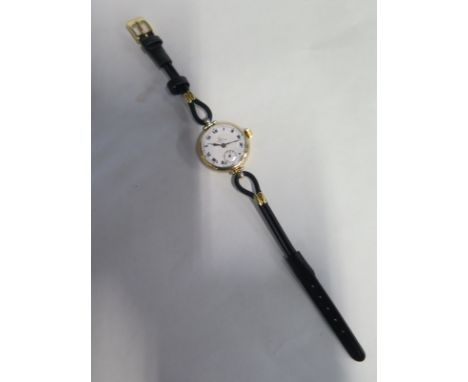 A 9ct ladies Omega wristwatch on black leather strap, manual wind 28mm wide including button, running, some wear to dial, oth