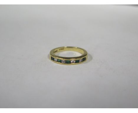 An 18ct emerald and diamond ring, approx 3.4 grams, size J/K, some wear to the band, otherwise in a clean condition 