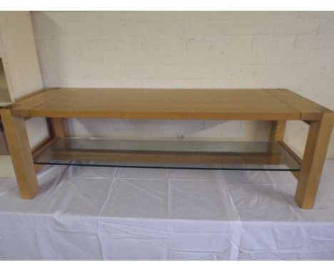 A Modern Rectangular Coffee Table with Glass Under Shelf.