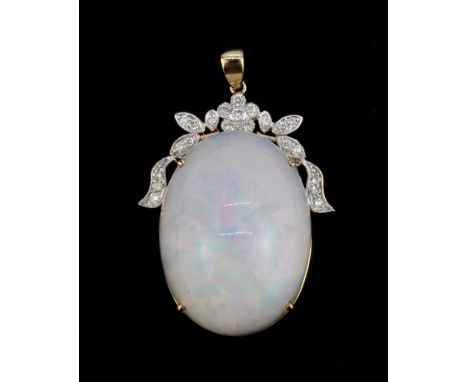 An impressive 18ct yellow gold mounted and diamond set opal pendant. Opal 2 x 2.5 cms 47ct.