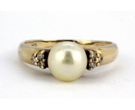 A 9ct yellow gold ring set with a cultured pearl and diamond shoulders. (M.5), W. 2.5g.