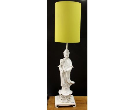 A mid 20th Century Chinese blanc de chine figure of the goddess Guanyin mounted as a table lamp, overall H. 84cm.