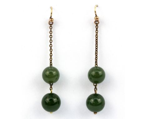 A pair of antique yellow metal mounted green jade drop earrings (metal chain) drop 5.5cms, jade beads 10mm diameter.