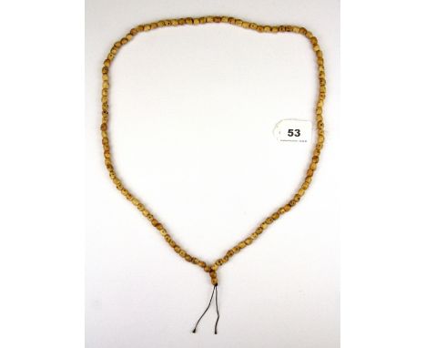 A strand of Tibetan carved Yak bone skull prayer beads used for prayers to tantric deities, folded L. 50cm.