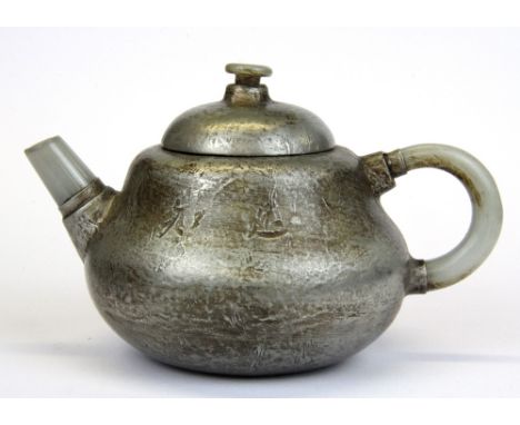 A Chinese pewter overlaid Yixing terracotta teapot with white jade spout and handle, H. 9cm.