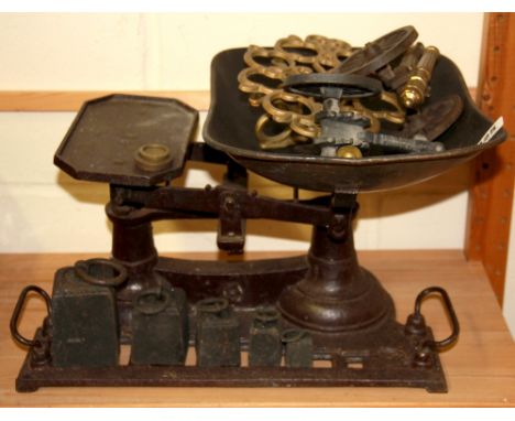A vintage cast iron scale and weights with a brass trivet and two cannons, scale W. 41cm.