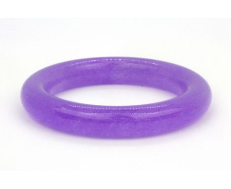 A lavender jade bangle, W. 12mm Internal Dia. 6cm.