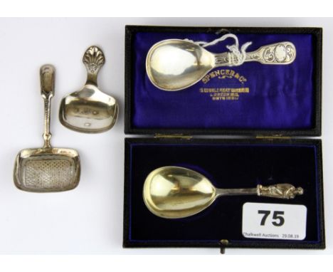 A cased hallmarked silver caddy spoon and three further caddy spoons.