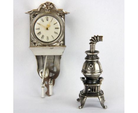 A Dutch silver miniature wall clock and a sterling silver stove, clock H. 7cm.