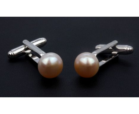 A pair of cream cutured pearl earrings 10mm on silver stems.