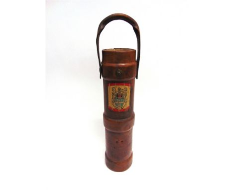 AN EARLY LEATHER SHELL CARRIER with swing overhandle converted to a stick/umbrella stand, 59cm high.