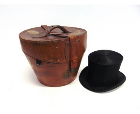 A GENT'S BLACK SILK TOP HAT size 61/4 inches with leather hat box by 'Army and Navy Co-operative Society Ltd.' and with the n