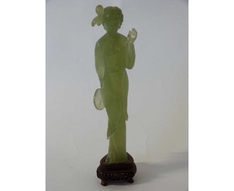 A jade figure of a Chinese lady on pierced wooden base, 22cm high