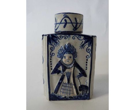 A dutch delft tea caddy 19/20th century with moulded decoration of figures in 18th century dress13cm highgood condition