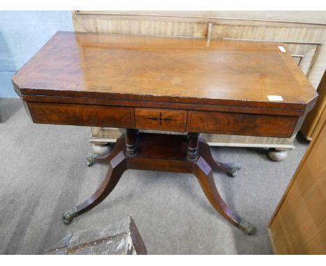 A George IV mahogany and inlaid card table with folding rectangular top opening to a baize lined interior raised on four turn