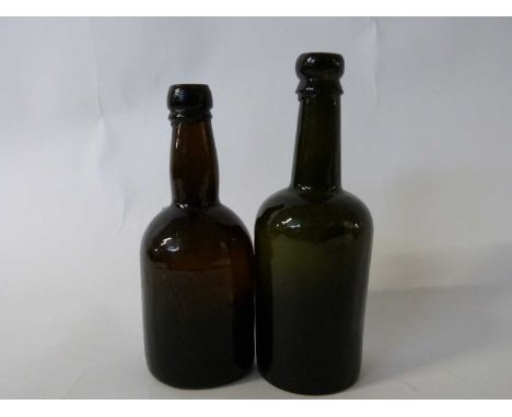 Two vintage dark green or black bottles, 21cm high