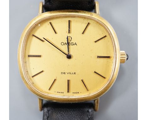 A gentleman's gold plated Omega de Ville manual wind wrist watch, on a black leather strap, with Omega buckle, case diameter 