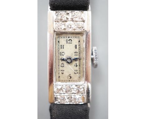 A lady's white meat (stamped Platinum) and diamond set rectangular manual wind cocktail watch, case diameter 11mm, on a black