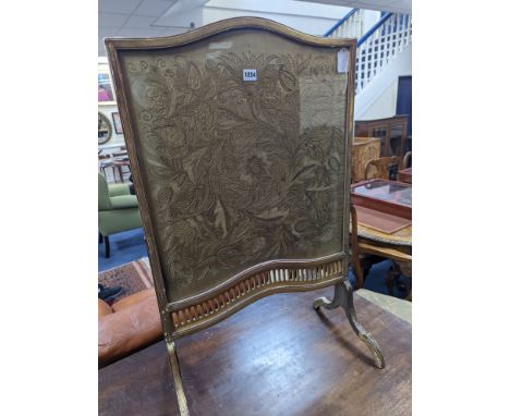 An Edwardian carved giltwood and needleworked firescreen, width 56cm, height 91cm
