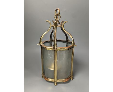 A brass hall lantern and a circular brass ceiling light fitting,hall lantern 40 cms high.