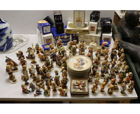 A large collection of Hummel pottery figures, approximately 70 including skier and two similar plaques, some with boxes.