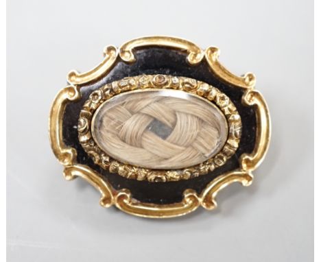 An early Victorian yellow metal, black enamel and plaited hair mourning brooch, inscribed verso, 'Revd. JWH Marshall Obt 23rd