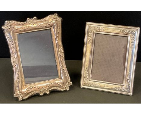 A contemporary silver easel easel Ribbon &amp; Roses photograph frame, London 1990, 21cm x 15.5cm;  another smaller, Sheffiel