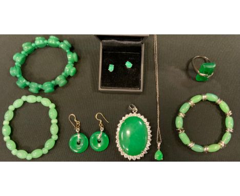 A pair of jade green cabochon earrings, white metal mount stamped 9k;  pair of similar coloured stone disc earrings, base met