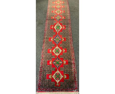 A Fine Persian hand-made Senneh runner carpet, 382cm x 92cm. 