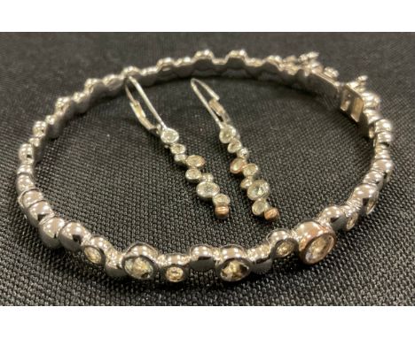A Clogau Welsh silver and white topaz hinge bangle; pair of similar earrings,