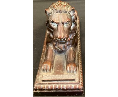 A late 19th century bronzed metal table lighter, cast as a Lion, hinged head enclosing oil reservoir, striker fore bar, 10cm 
