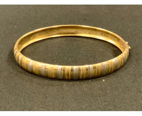 A 9ct gold two tone textured bangle, 6.1g 