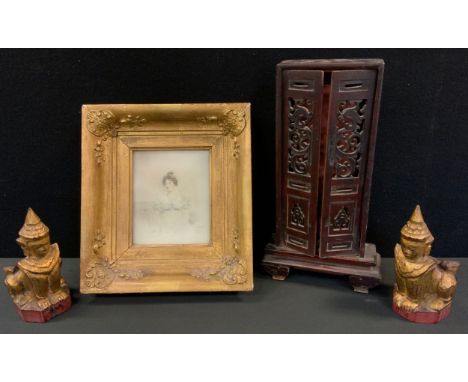 A Chinese family shrine cabinet, pierced doors, scroll feet, the boards for the relatives of Sz-To-Way, 34cm high, 18cm wide,