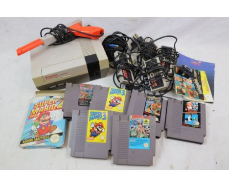 Original Nintendo NES console plus 4 controllers, gun and 7 x game cartridges including boxed Super Mario 2, WWF Wrestlemania