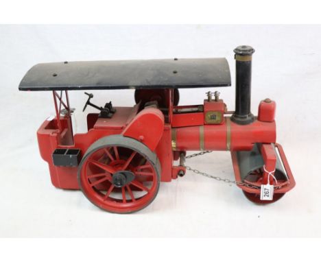 Scratch built steam roller model in red, wooden and tin with metal fittings, 22" in approx length, missing one wheel 