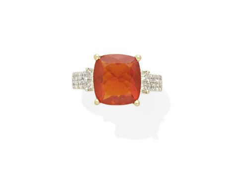 A fire opal and diamond ringcentering a fire opal measuring approximately 11.80 x 10.40 x 5.92mm; mounted in 14k gold; size: 