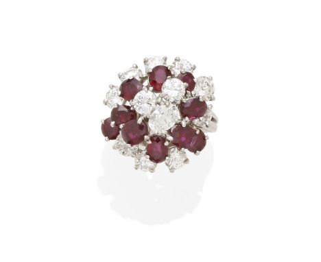 A ruby and diamond cluster ring mounted in platinum; estimated total diamond weight: 3.35cts; size: 5 1/4