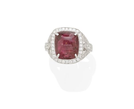 A ruby and diamond ringcentering a sugarloaf cabochon-cut ruby measuring approximately 11.73 x 10.72 x 9.78mm; mounted in 18k