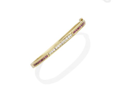 A ruby and diamond bangle mounted in 14k gold; length: 7in.