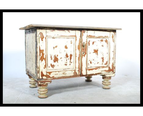 A vintage 20th century up - cycled shabby chic pine cupboard, scrubbed top over twin panel doors raised on turned legs.&nbsp;