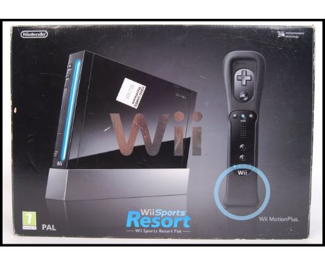 A black edition Nintendo Wii, Wii Sports Resort console set. Appears complete, with games, controller &amp; power adapter. Wi