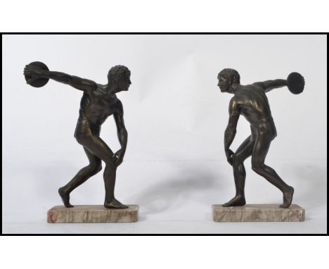 A pair of late 19th / early 20th century brown bronze cast figures of a classical discus throwers, each raised&nbsp; on a mar