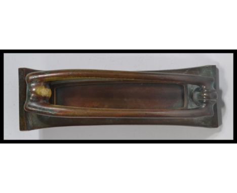 A 19th century Victorian Art Nouveau bronze door knocker and letterbox of rectangular form with tubular knocker and spring ac